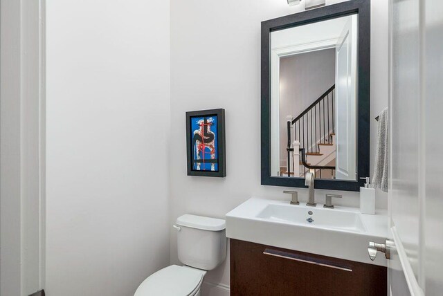 bathroom featuring vanity and toilet