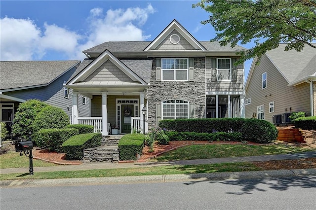595 Stonepark Ln, Suwanee, GA 30024 - view of front facade with stone siding, a porch, roof with shingles, and cooling unit
