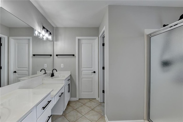 595 Stonepark Ln, Suwanee, GA 30024 - full bathroom featuring a stall shower, double vanity, tile patterned floors, and baseboards