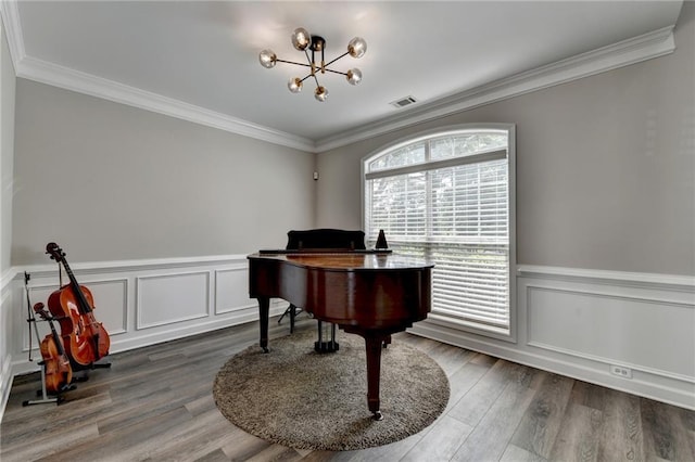 595 Stonepark Ln, Suwanee, GA 30024 - sitting room with a chandelier, ornamental molding, wainscoting, wood finished floors, and a decorative wall