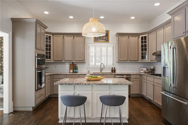 1003 N Ave NE, Atlanta, GA 30306 - kitchen with appliances with stainless steel finishes, a sink, glass insert cabinets, dark wood-type flooring, and a breakfast bar