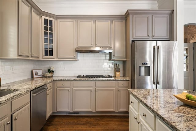1003 N Ave NE, Atlanta, GA 30306 - kitchen with stainless steel appliances, under cabinet range hood, backsplash, glass insert cabinets, and ornamental molding