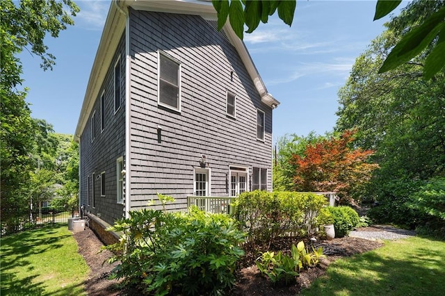 1003 N Ave NE, Atlanta, GA 30306 - view of property exterior featuring a wooden deck, a lawn, and central AC