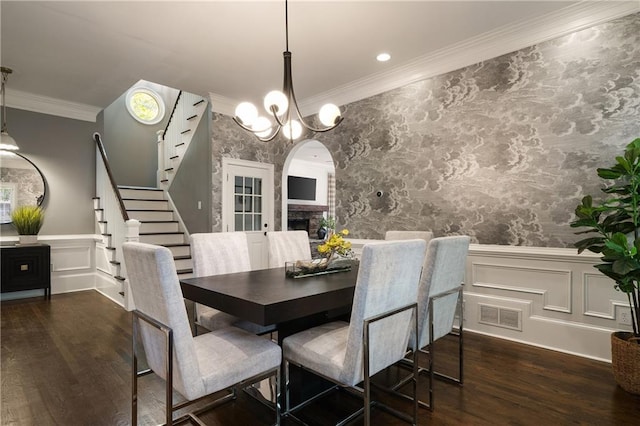 1003 N Ave NE, Atlanta, GA 30306 - dining area featuring arched walkways, a wainscoted wall, wood finished floors, ornamental molding, and stairs