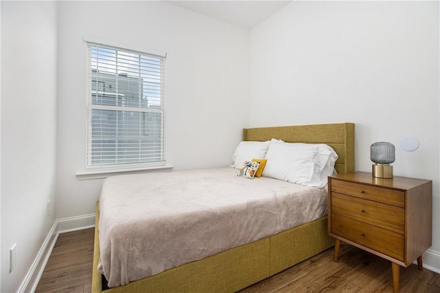 bedroom with wood finished floors and baseboards