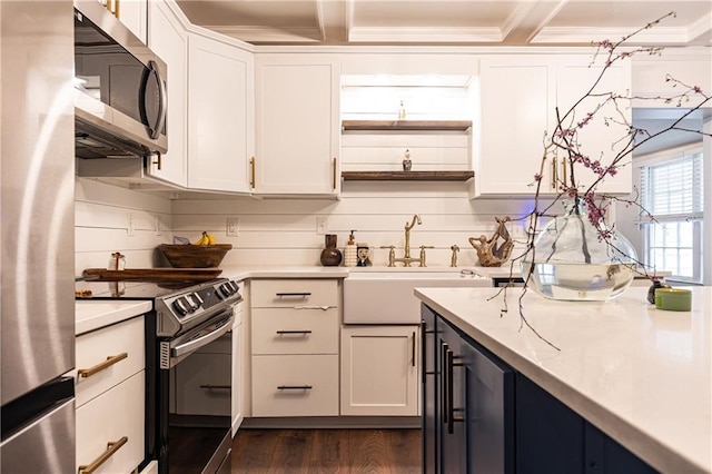 1443 Fama Dr NE, Atlanta, GA 30329 - kitchen with stainless steel appliances, light countertops, white cabinets, dark wood finished floors, and ornamental molding