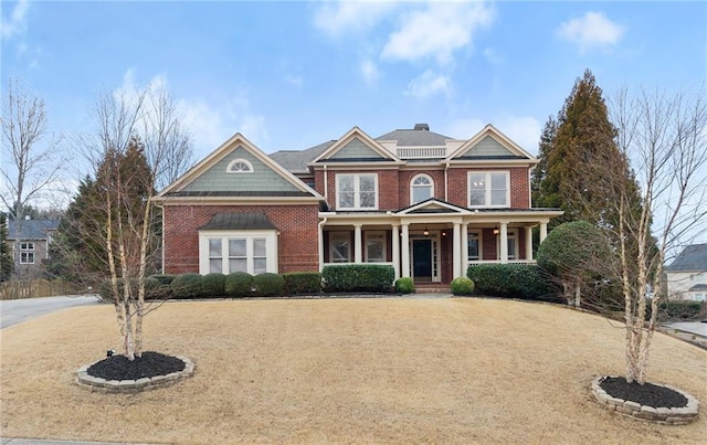 view of front of property featuring covered porch and a front lawn