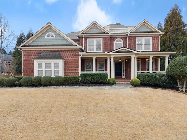 view of front of property with a porch and a front yard