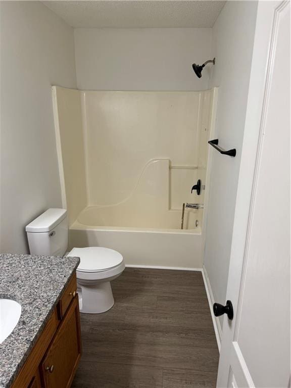 full bathroom with toilet, tub / shower combination, wood finished floors, and vanity