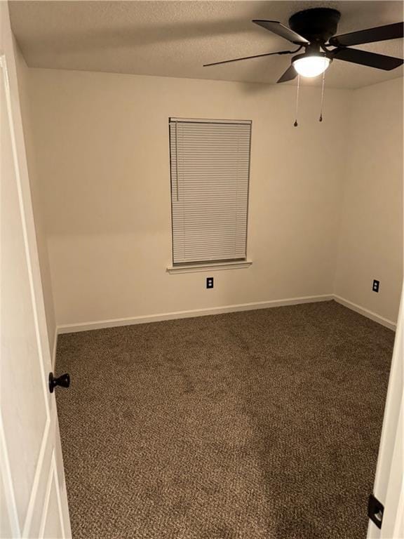 unfurnished room with baseboards, ceiling fan, and carpet