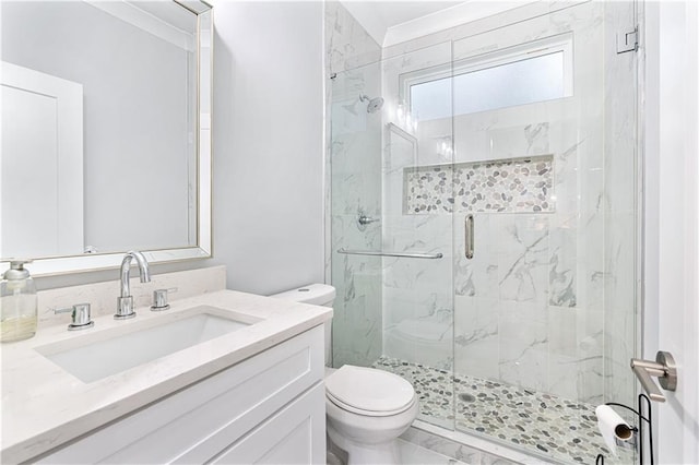 bathroom with walk in shower, vanity, and toilet