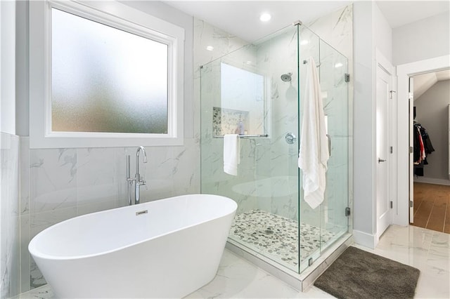 bathroom with separate shower and tub