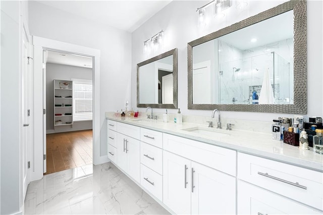 bathroom featuring walk in shower and vanity