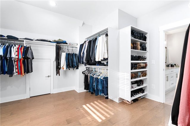 spacious closet with light hardwood / wood-style floors