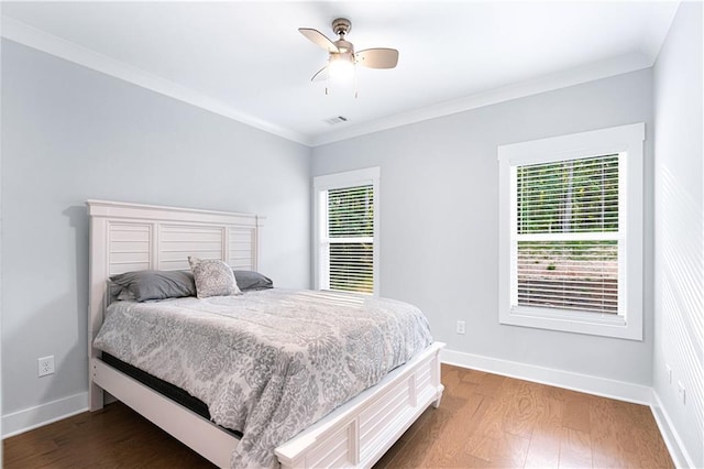 bedroom with multiple windows, ceiling fan, crown molding, and dark hardwood / wood-style floors