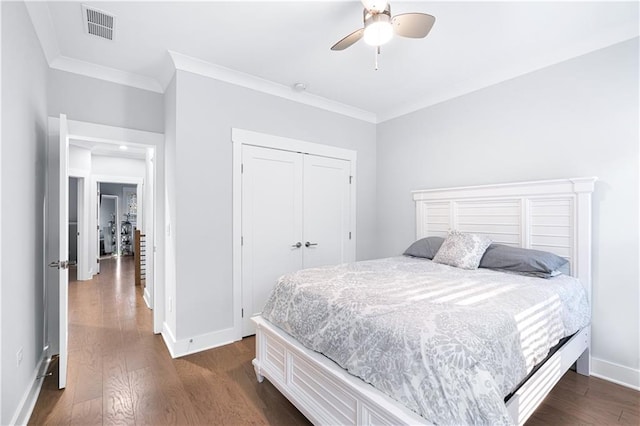 bedroom featuring a closet, ceiling fan, crown molding, and dark wood-type flooring