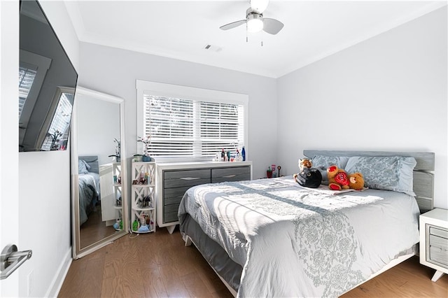 bedroom with ornamental molding, ceiling fan, and dark hardwood / wood-style flooring