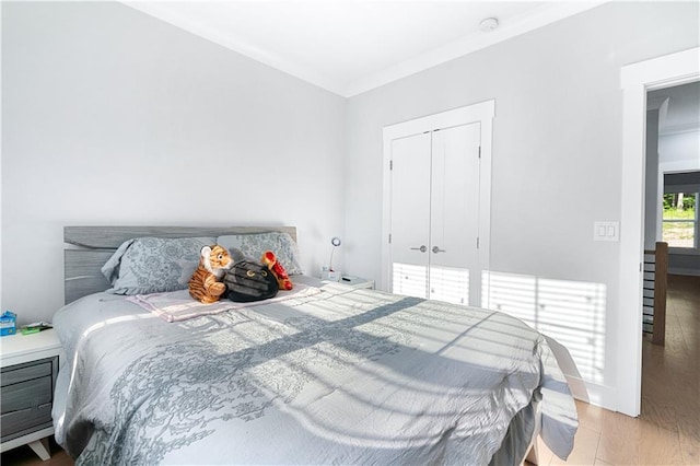 bedroom featuring light hardwood / wood-style flooring and a closet