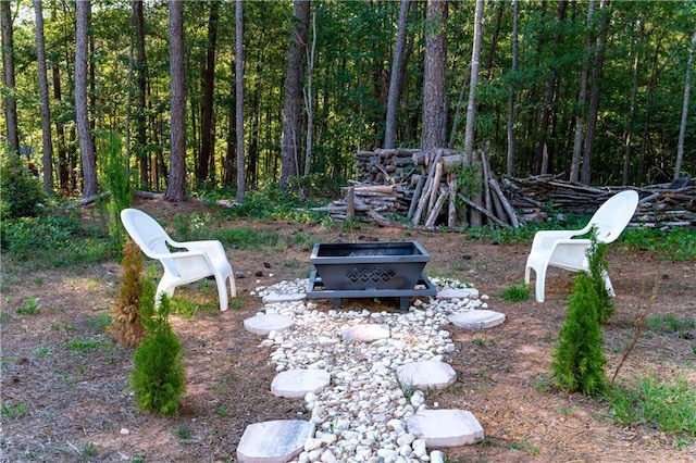 view of yard with an outdoor fire pit