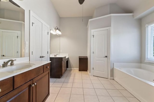 bathroom featuring vanity, tile patterned floors, ceiling fan, and a washtub