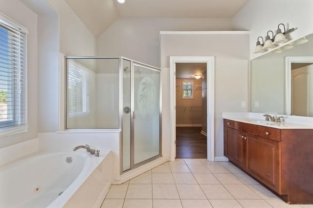 bathroom featuring vanity, lofted ceiling, plus walk in shower, and tile patterned flooring