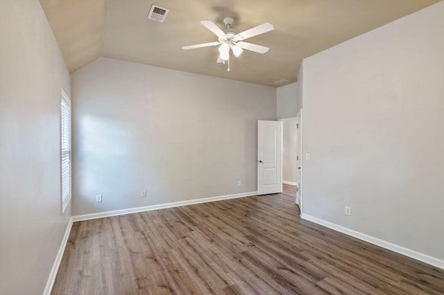 empty room featuring hardwood / wood-style floors, vaulted ceiling, and ceiling fan