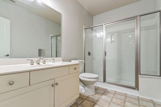 bathroom with vanity, toilet, and an enclosed shower