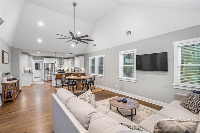 1375 Miller Reed Ave SE, Atlanta, GA 30315 - living area featuring dark wood-style flooring, high vaulted ceiling, a ceiling fan, a healthy amount of sunlight, and visible vents
