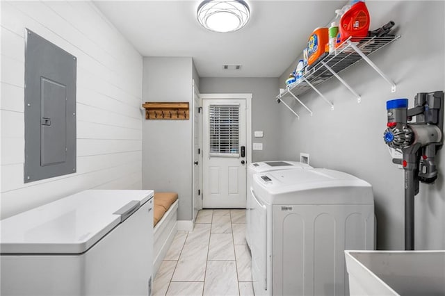 laundry room with sink, washing machine and clothes dryer, and electric panel