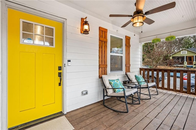 entrance to property featuring ceiling fan and a porch