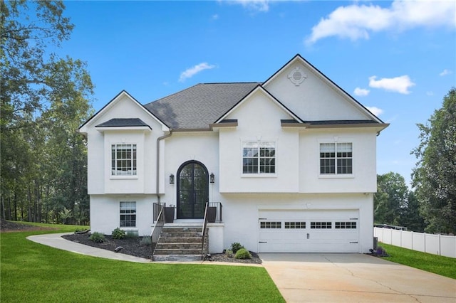 split foyer home with a garage and a front lawn