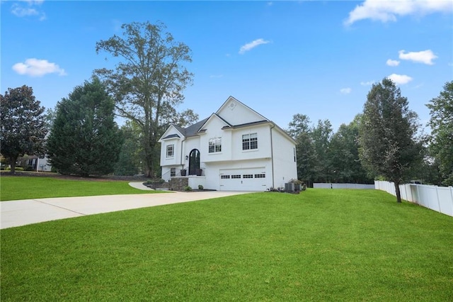 view of front of property with a garage, a front yard, and central AC unit