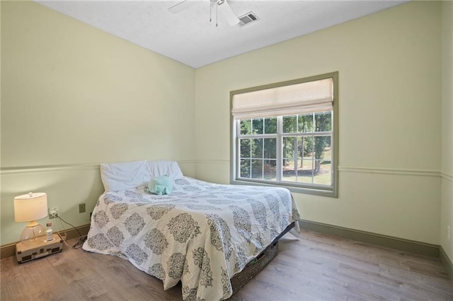 bedroom with light wood-type flooring and ceiling fan