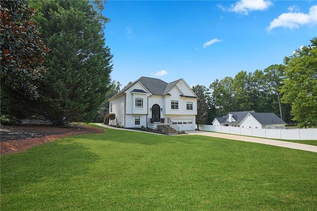 view of front of property with a garage and a front lawn