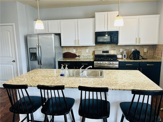 kitchen featuring white cabinetry, backsplash, pendant lighting, and stainless steel appliances