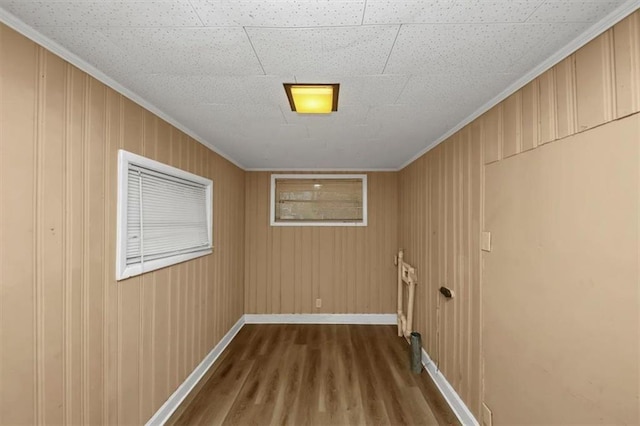 laundry room with hardwood / wood-style floors and ornamental molding