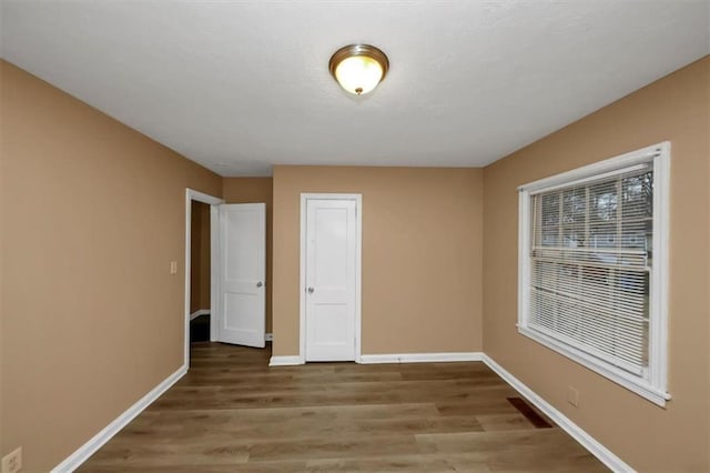 unfurnished bedroom featuring hardwood / wood-style flooring and a closet