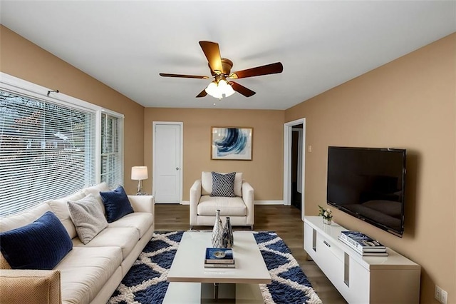 living room with dark wood-type flooring and ceiling fan