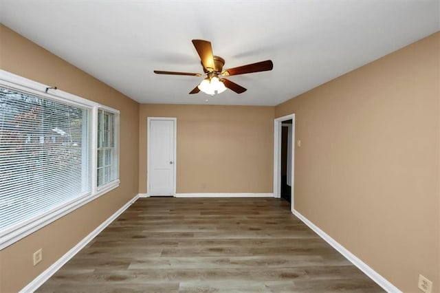 unfurnished room featuring hardwood / wood-style flooring and ceiling fan