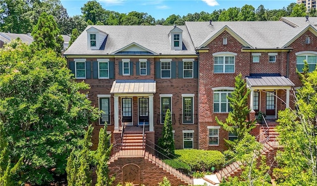 2828 Broughton Ln SE, Atlanta, GA 30339 - view of front facade with stairway, brick siding, a porch, and a standing seam roof