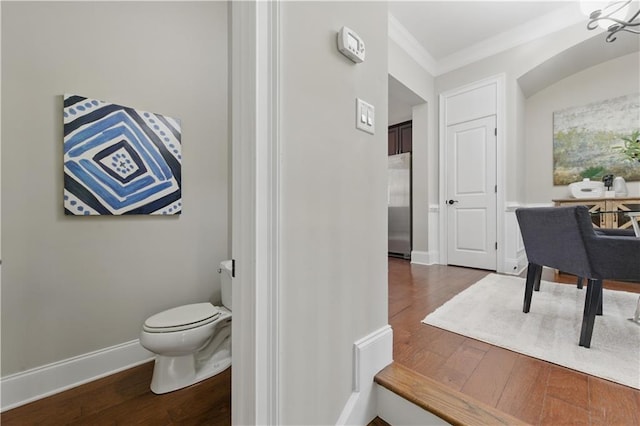 2828 Broughton Ln SE, Atlanta, GA 30339 - bathroom with wood-type flooring, toilet, crown molding, and baseboards