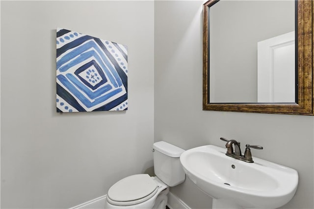 2828 Broughton Ln SE, Atlanta, GA 30339 - bathroom featuring a sink, baseboards, and toilet