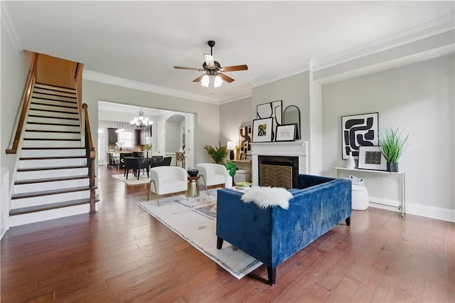 2828 Broughton Ln SE, Atlanta, GA 30339 - living room featuring stairs, a ceiling fan, hardwood / wood-style floors, a fireplace, and a chandelier