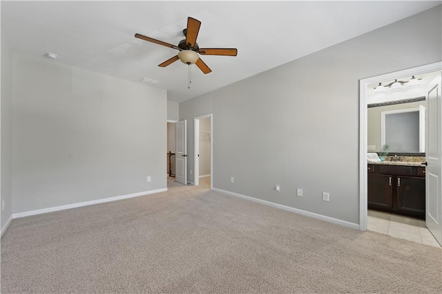 2828 Broughton Ln SE, Atlanta, GA 30339 - unfurnished bedroom featuring light carpet, baseboards, a walk in closet, and ensuite bath