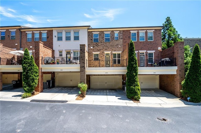 2828 Broughton Ln SE, Atlanta, GA 30339 - view of front of property with brick siding, an attached garage, driveway, and central AC unit