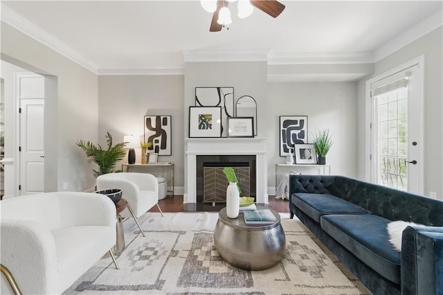 2828 Broughton Ln SE, Atlanta, GA 30339 - living area with crown molding, a ceiling fan, wood finished floors, a fireplace with flush hearth, and baseboards