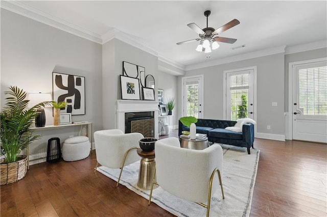 2828 Broughton Ln SE, Atlanta, GA 30339 - living area with wood-type flooring, ceiling fan, crown molding, a fireplace, and baseboards