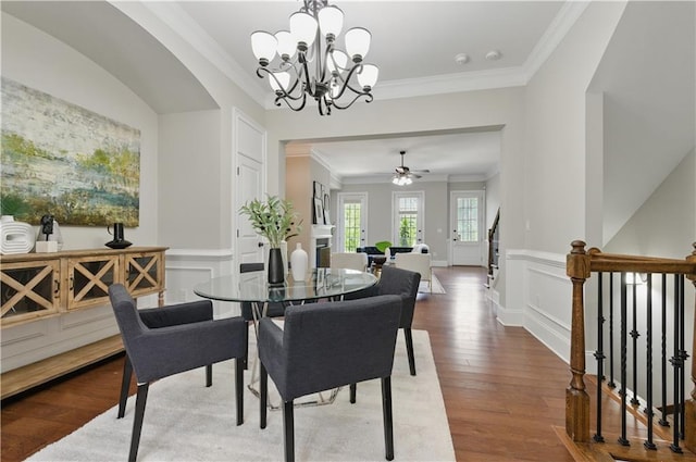 2828 Broughton Ln SE, Atlanta, GA 30339 - dining room featuring crown molding, a chandelier, wood finished floors, ceiling fan, and a decorative wall