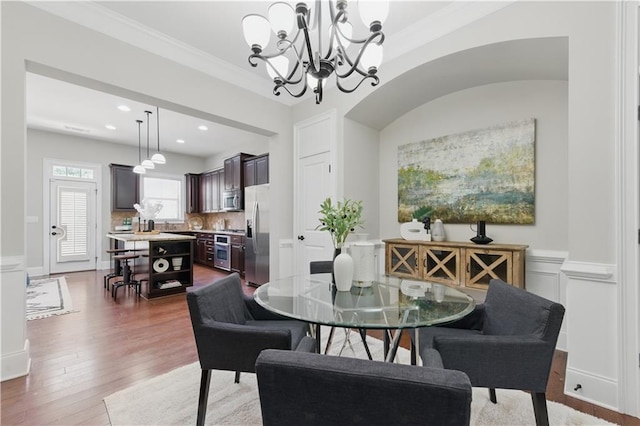2828 Broughton Ln SE, Atlanta, GA 30339 - dining space featuring a chandelier, wood finished floors, ornamental molding, a wainscoted wall, and recessed lighting