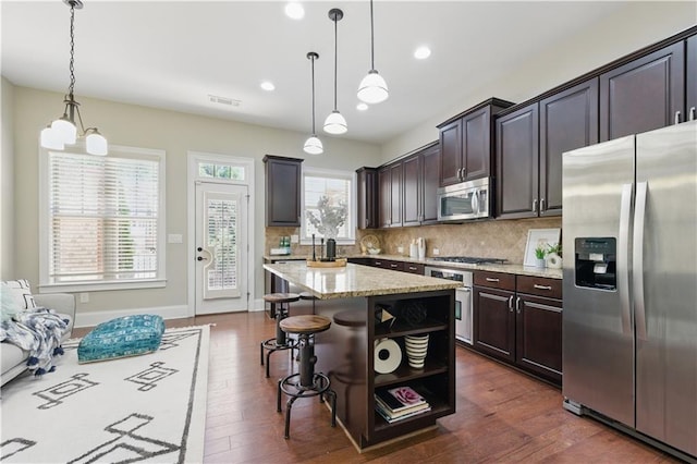 2828 Broughton Ln SE, Atlanta, GA 30339 - kitchen with stainless steel appliances, backsplash, dark wood-style flooring, light stone counters, and recessed lighting